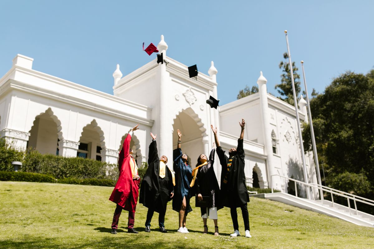 College graduates tossing their caps in the air during a graduation celebration.