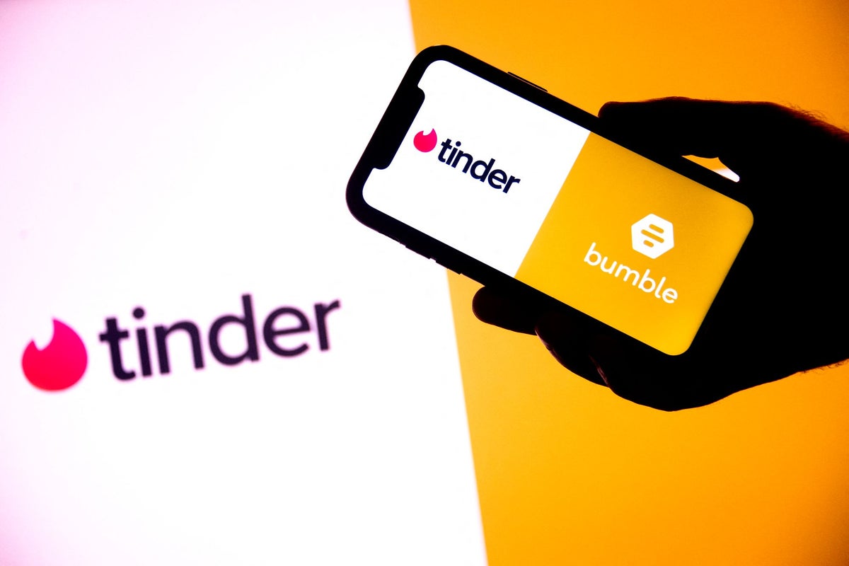 A young person using a dating app on their phone.